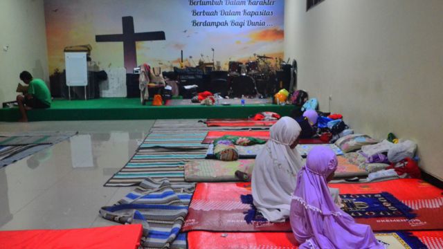 Pengungsi korban banjir melakukan shalat di ruang aula Gereja Kristen Muria Indonesia (GKMI) Tanjung Karang, Kudus, Jawa Tengah, Rabu (04/01).